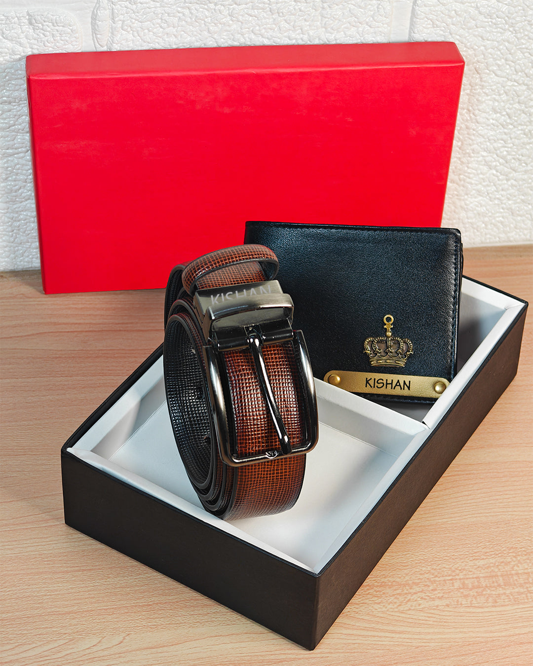 Brown belt and black wallet set in a box with a red background