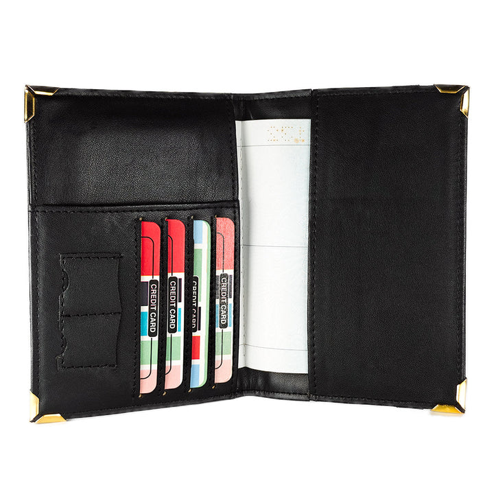 Black passport cover with card slots and a money clip on a white background