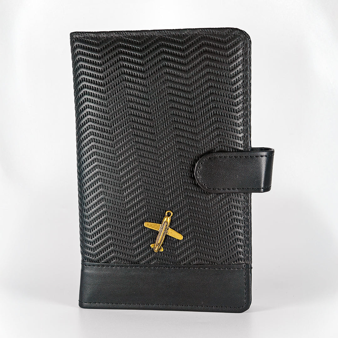 Black textured leather wallet with gold airplane emblem on a white background