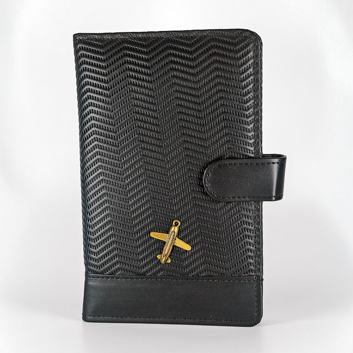 Black textured leather wallet with gold airplane emblem on a white background