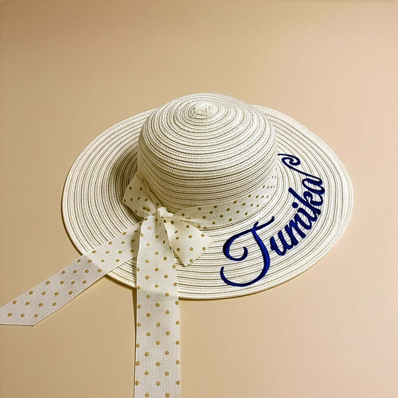 Beige straw hat with a polka dot ribbon and &