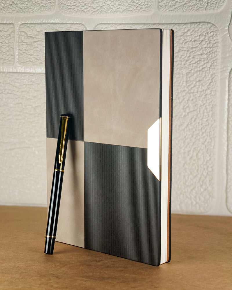 Notebook with geometric design and a pen on a textured surface