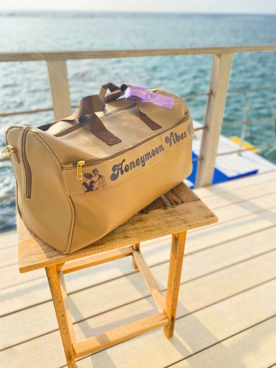 Personalized Travel Duffle Bag - Stylish Beige Leather inmaldives with the quote honeymoon vibes on it