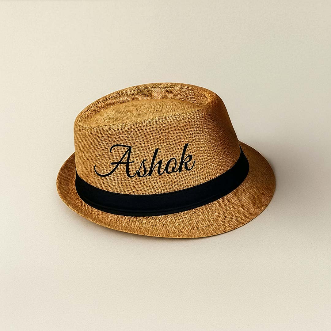 Brown hat with 'Ashok' text and black band on a beige background