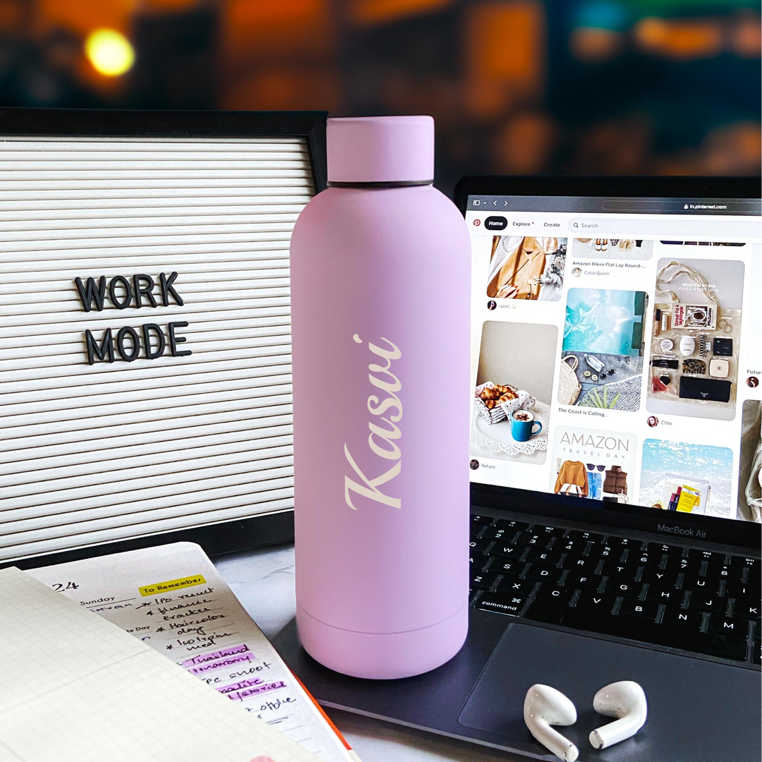 A custom engraved, hot pink stainless steel water bottle with the text &
