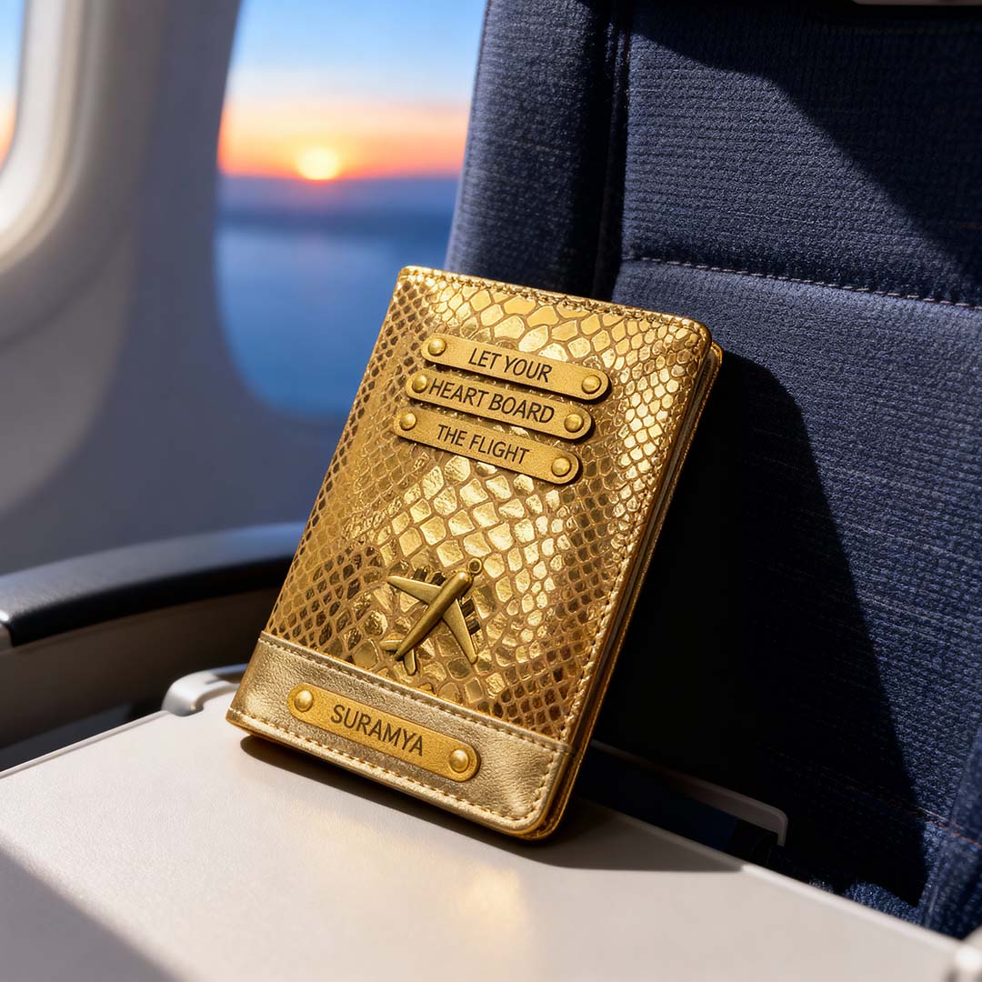 Gold textured passport holder with engraved text on a plane seat