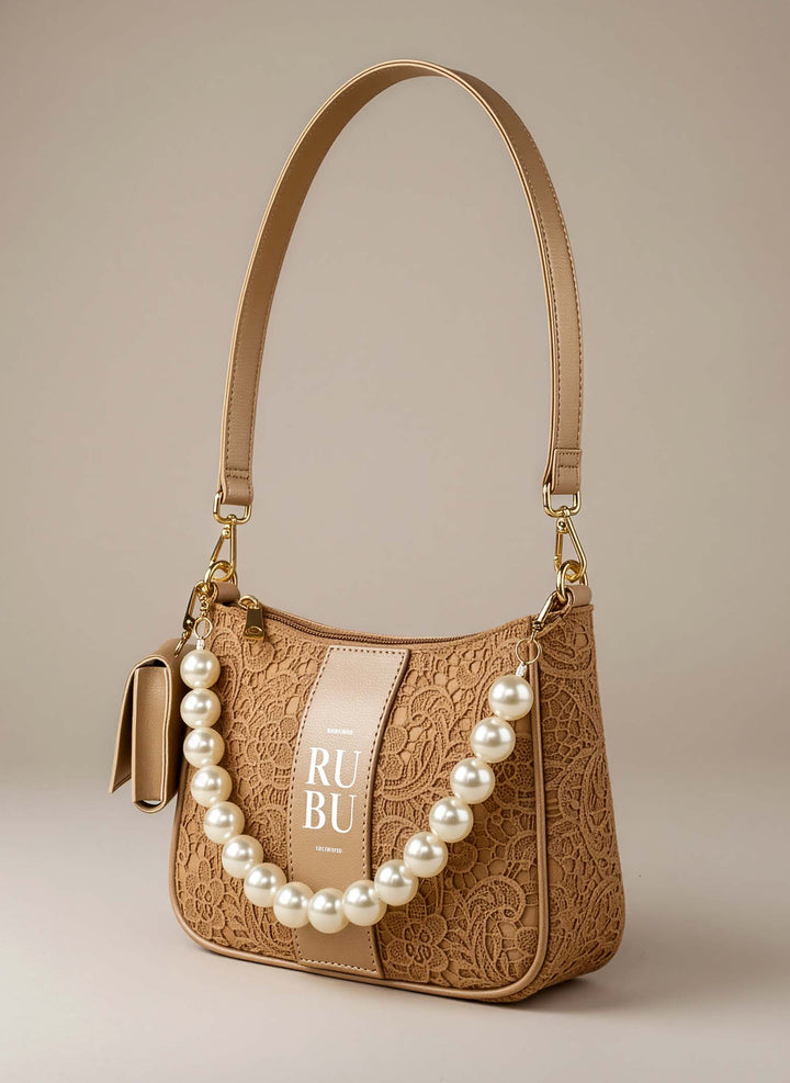 Beige handbag with pearl embellishments on a beige background
