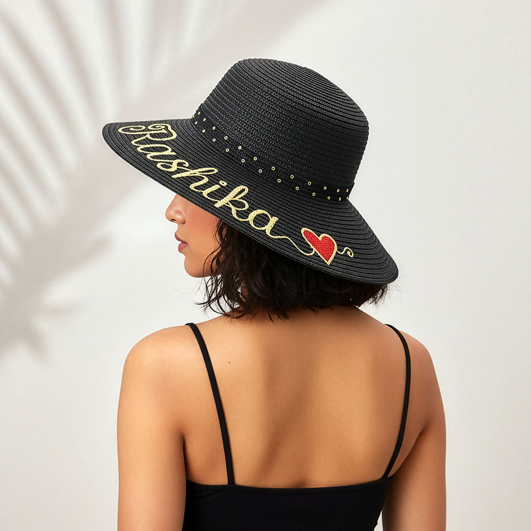 Black sun hat with 'Rashika' and a heart design on a white background