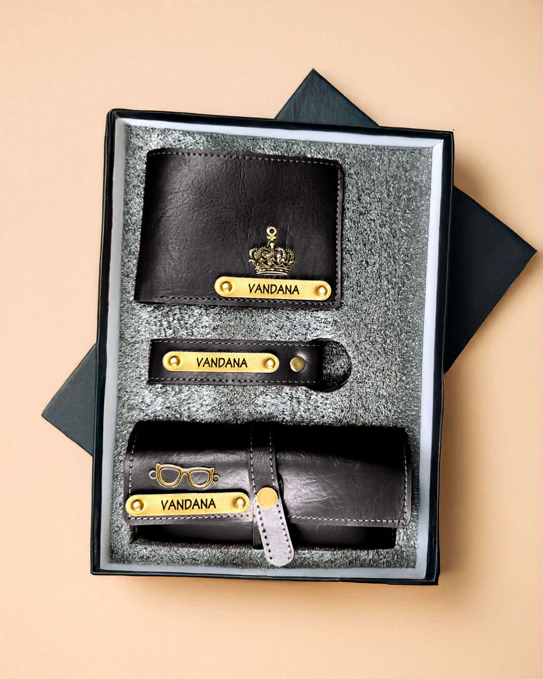 Black leather wallet set with 'Vandana' branding in a box on a beige background