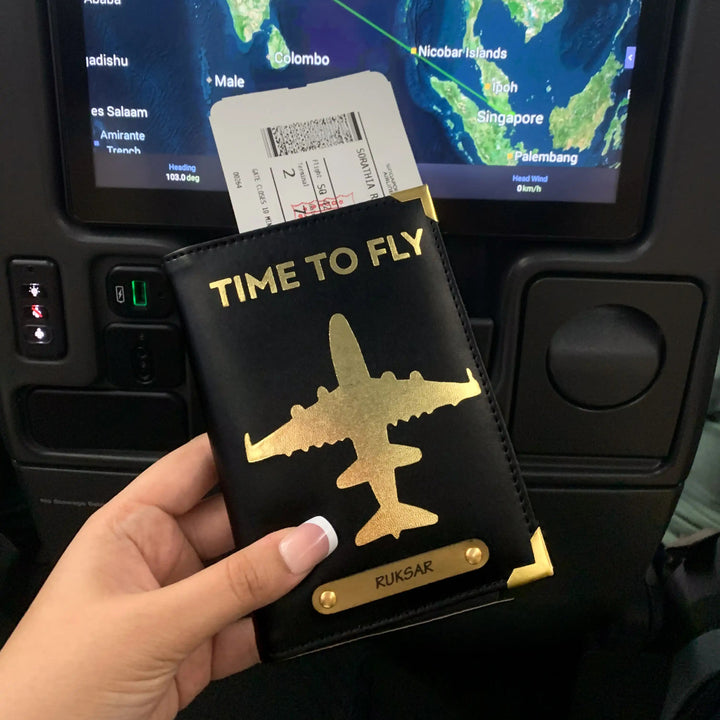 Black premium passport cover held in hand in plane