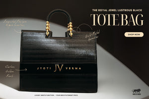 Black personalized tote bag with gold accents on a dark background, featuring the brand 'IV' and text promoting the product by TPC Gifts