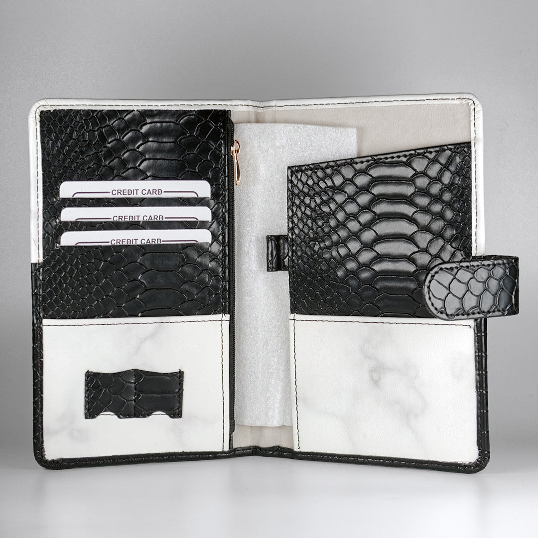Custom passport holder and travel organizer with black textured design, featuring gold foil ‘Adventure Awaits’ text – a premium passport cover for travel lovers.