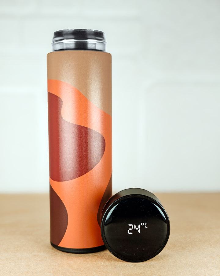 Tumbler with brown and orange design on a light background