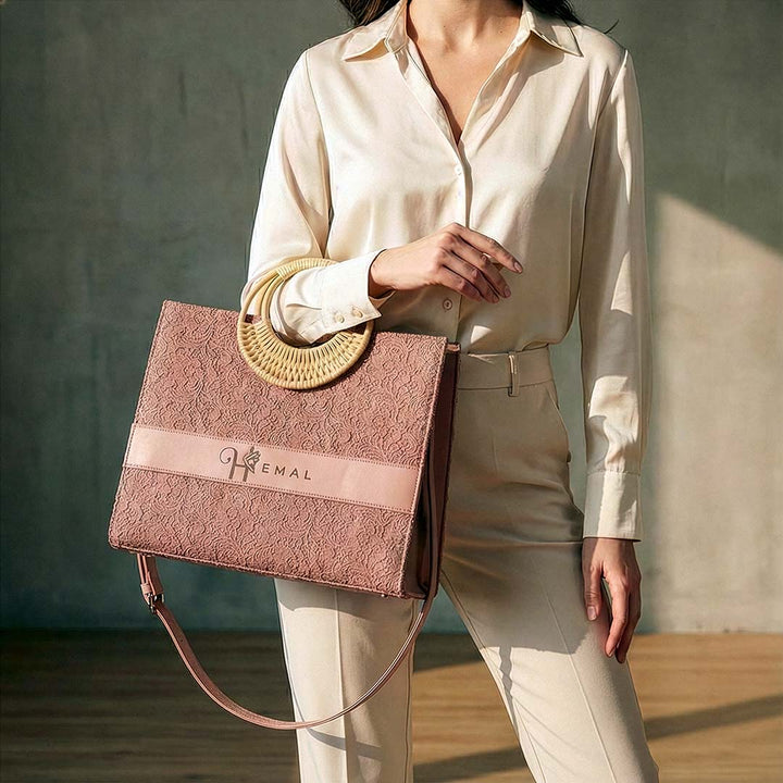 Person holding a textured pink handbag with &