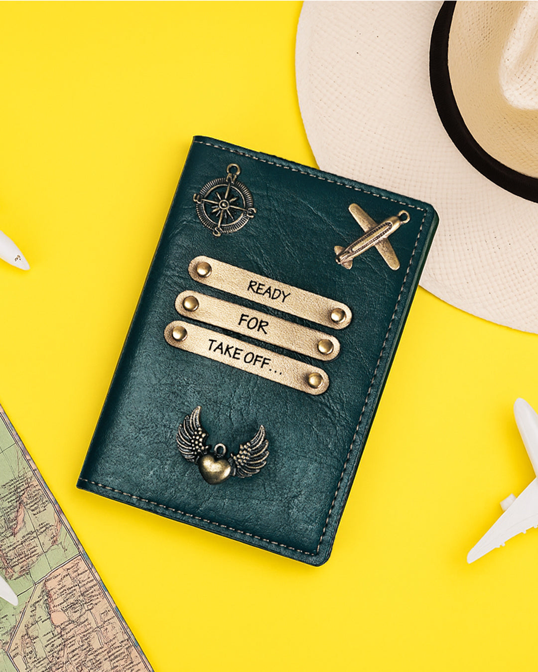 Green passport holder with decorative elements on a yellow background