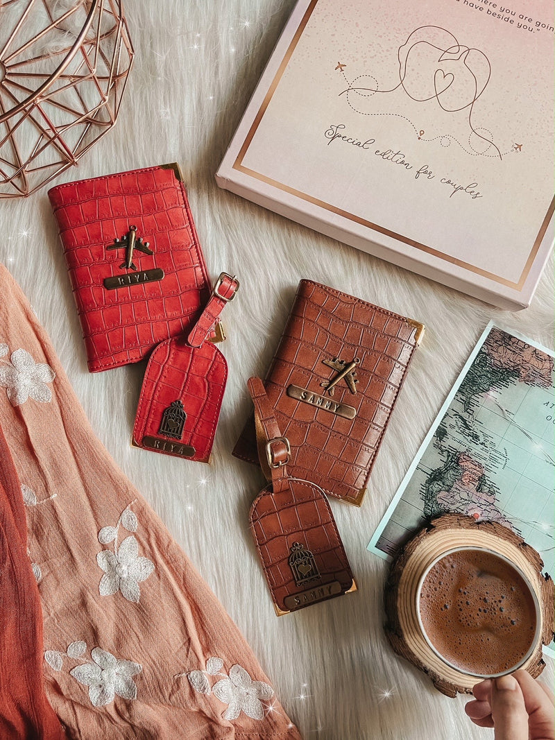 Couple Passport Cover & Luggage Tag - Cheery red and brown in colour in a flat lay along with a gift box and a cup of tea and a map by TPC Gifts. 