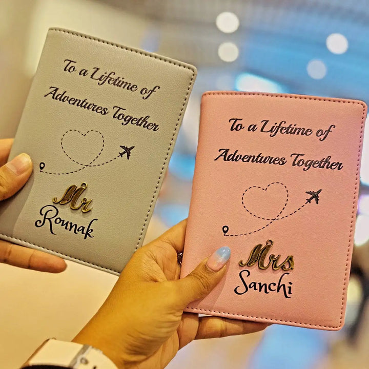  Two people holding up TPC Gifts passport covers with a couple&