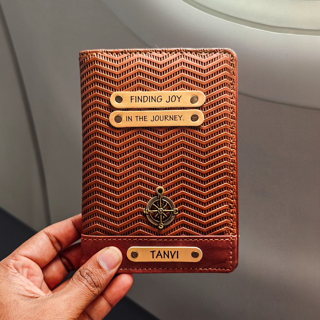 A personalized passport cover in light brown with a textured pattern, holding by a hand, with the name &
