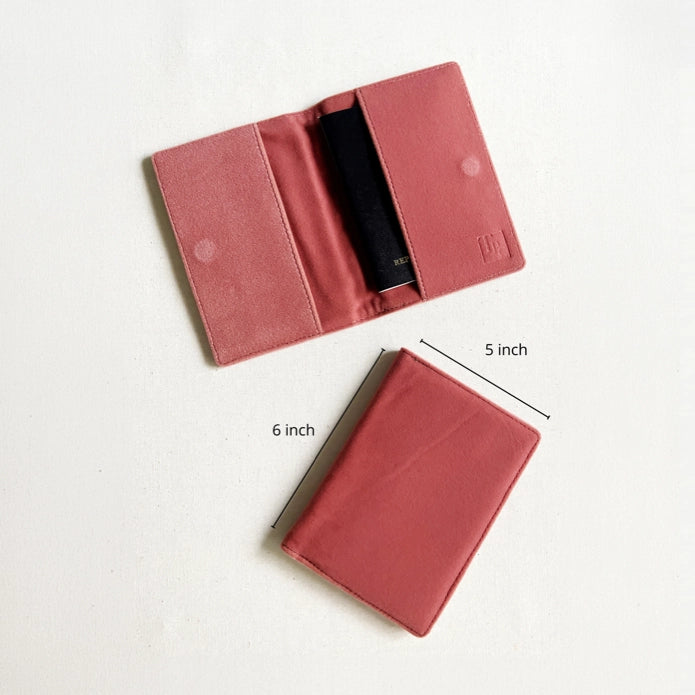 A dusty rose pink card holder wallet shown in two views on a white background: one open to show a black card inside, and one closed with dimension lines indicating 5 inch by 6 inch measurements.