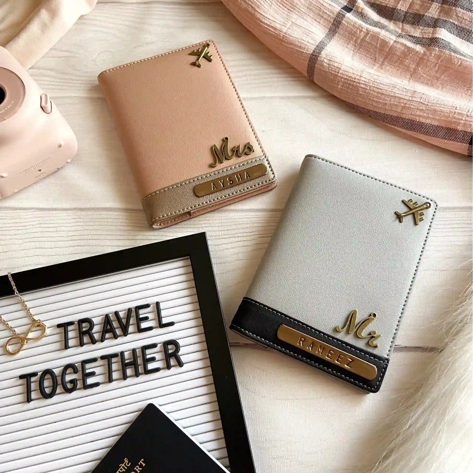 Personalised Two leather passport cover wallets styled on a light wood surfaceDual Tone Antique Pink & Grey Black Couple Passport Cover - TPC Gifts.
