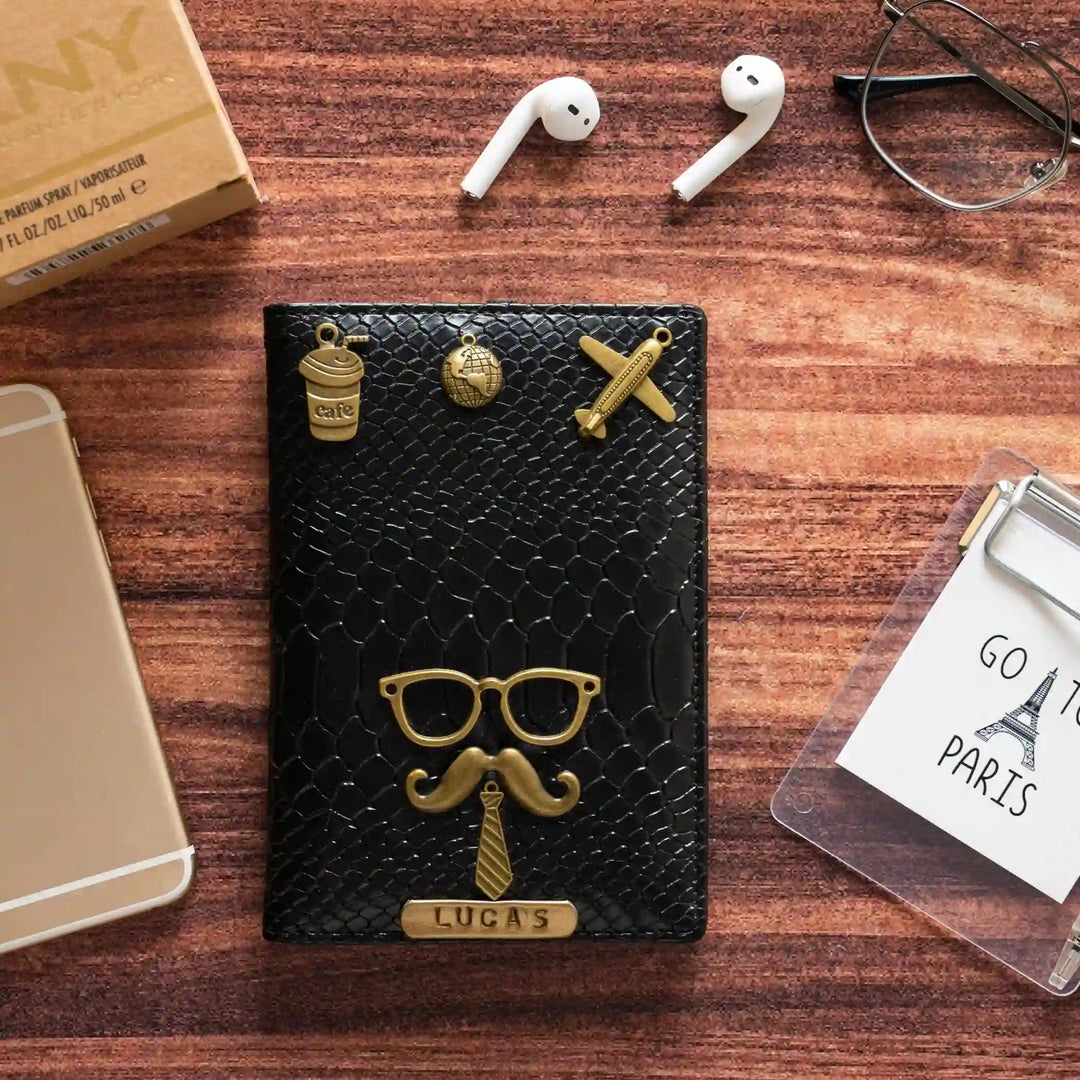 Black snake Passport Cover texture with gold-tone metal accents, including a mustache and glasses design, a &