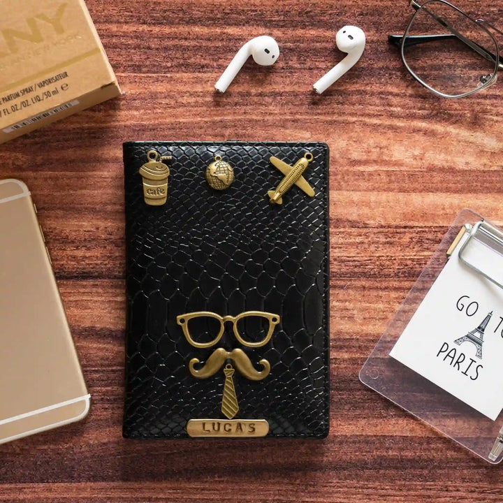 Black snake Passport Cover texture with gold-tone metal accents, including a mustache and glasses design, a &
