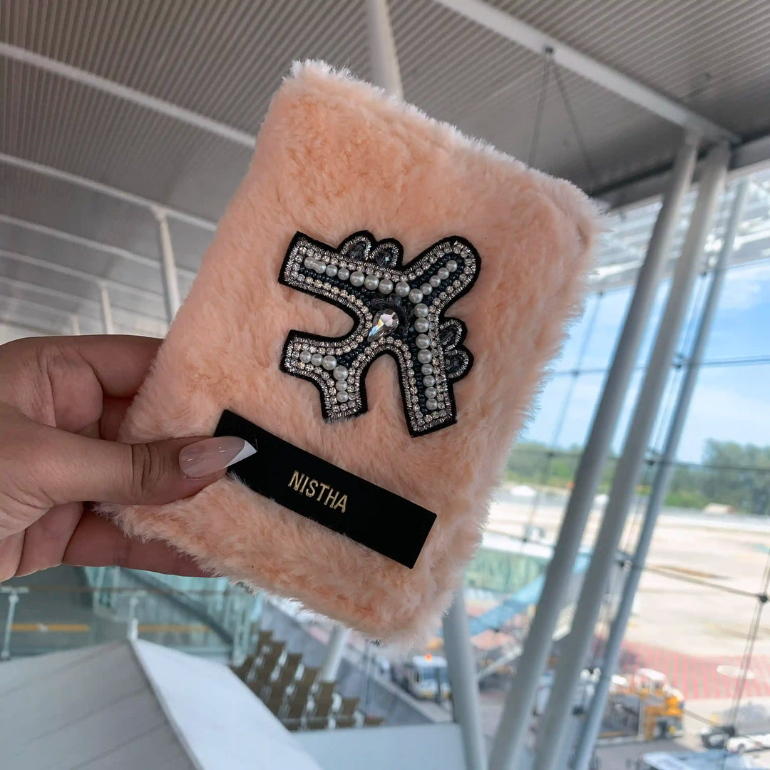 Salmon furr passport cover held in hand at the airport - TPC Gifts
