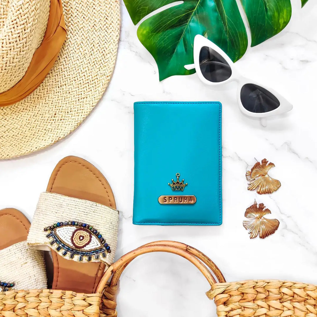 A turquoise blue passport cover with a gold crown and &