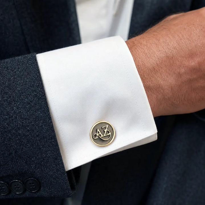 Close-up of a cufflink on a white shirt cuff with a dark suit jacket -TPC Gifts