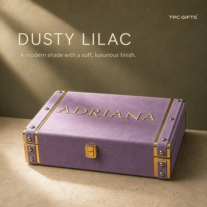 A dusty lilac personalized jewelry box with gold trim and the name &