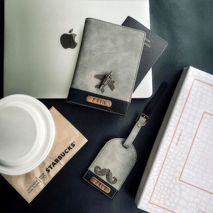 Gray leather passport holder with airplane emblem and &