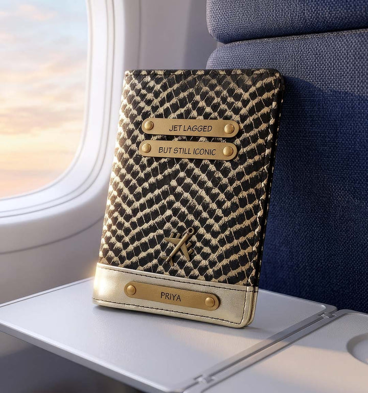 Patterned passport holder with gold accents on an airplane tray table by tpc gifts