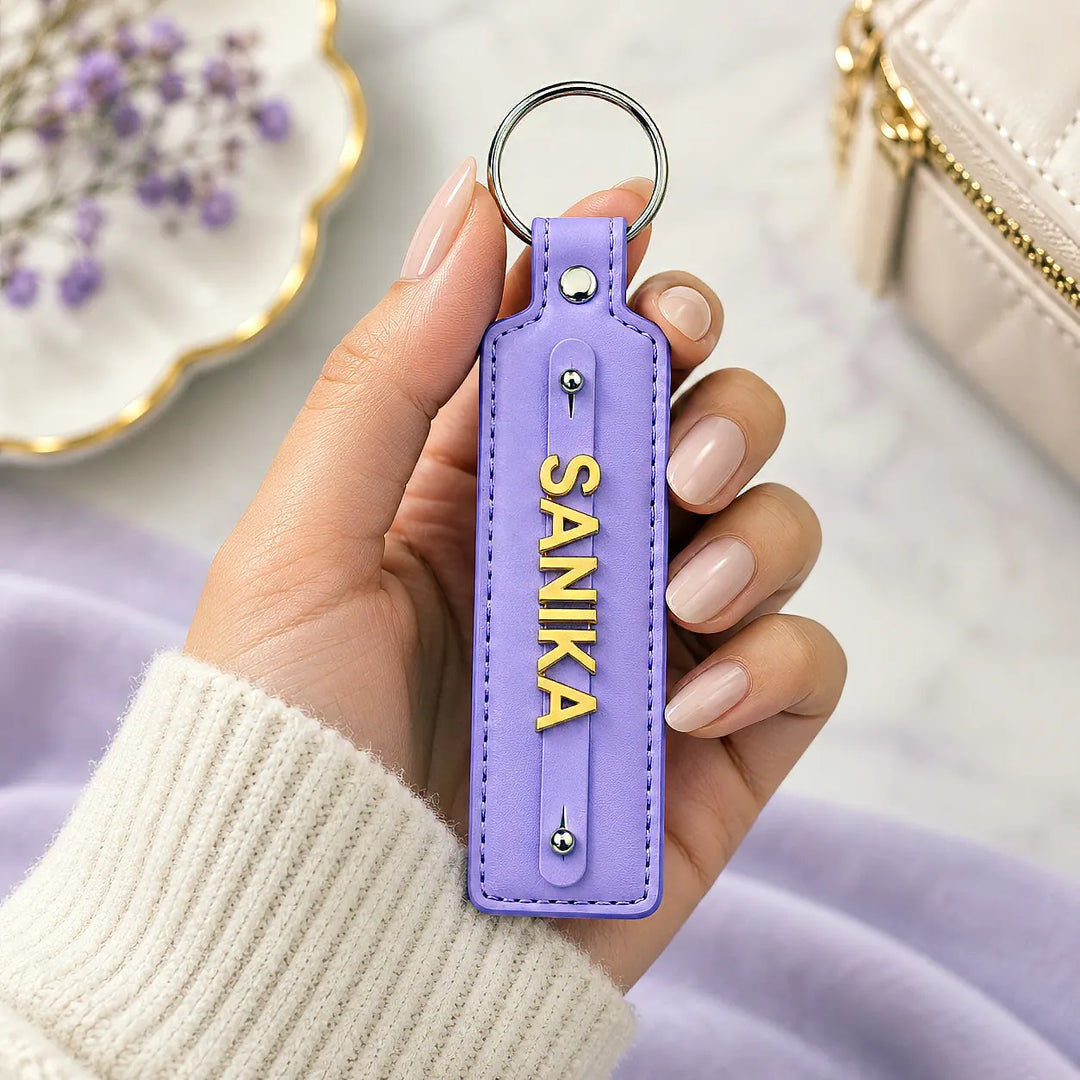 Lavender vegan-leather keychain with gold-tone name letters
