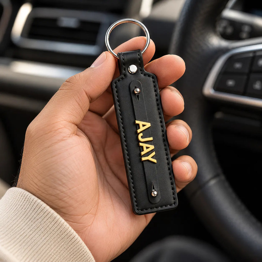 Dark vegan-leather personalised keychain shown with car keys