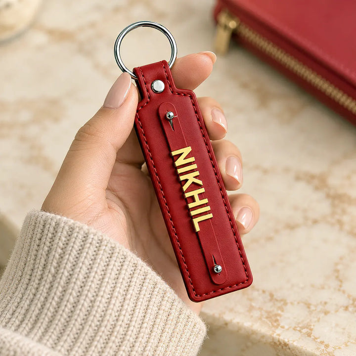 Red vegan-leather keychain with gold-tone name letters