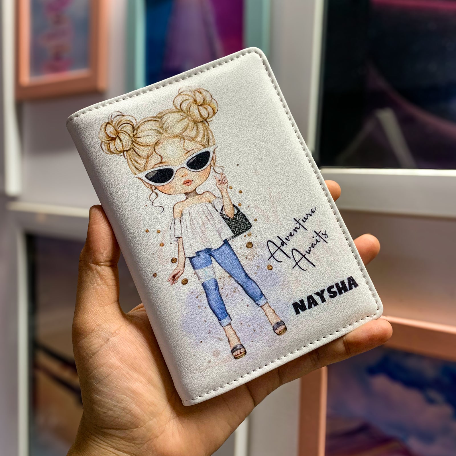 A passport cover with an illustration of a girl in sunglasses and a denim outfit, holding a passport, with a customized name 'Anastasia' and a date '2023' written on the cover.