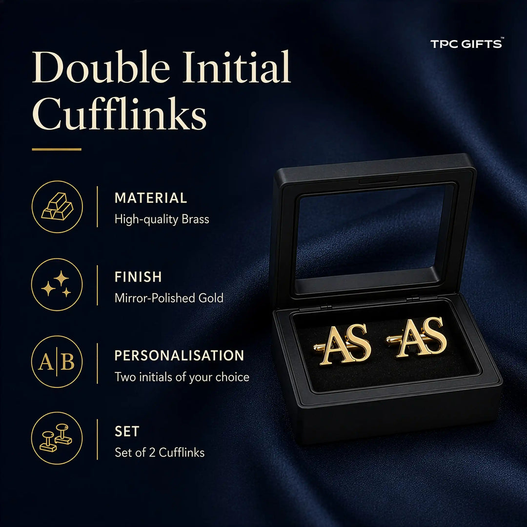 A pair of gold double initial cufflinks displayed in an open black presentation box on a dark navy satin background, with promotional text on the left reading &