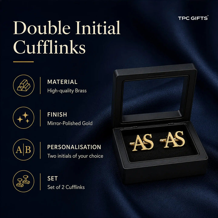A pair of gold double initial cufflinks displayed in an open black presentation box on a dark navy satin background, with promotional text on the left reading &