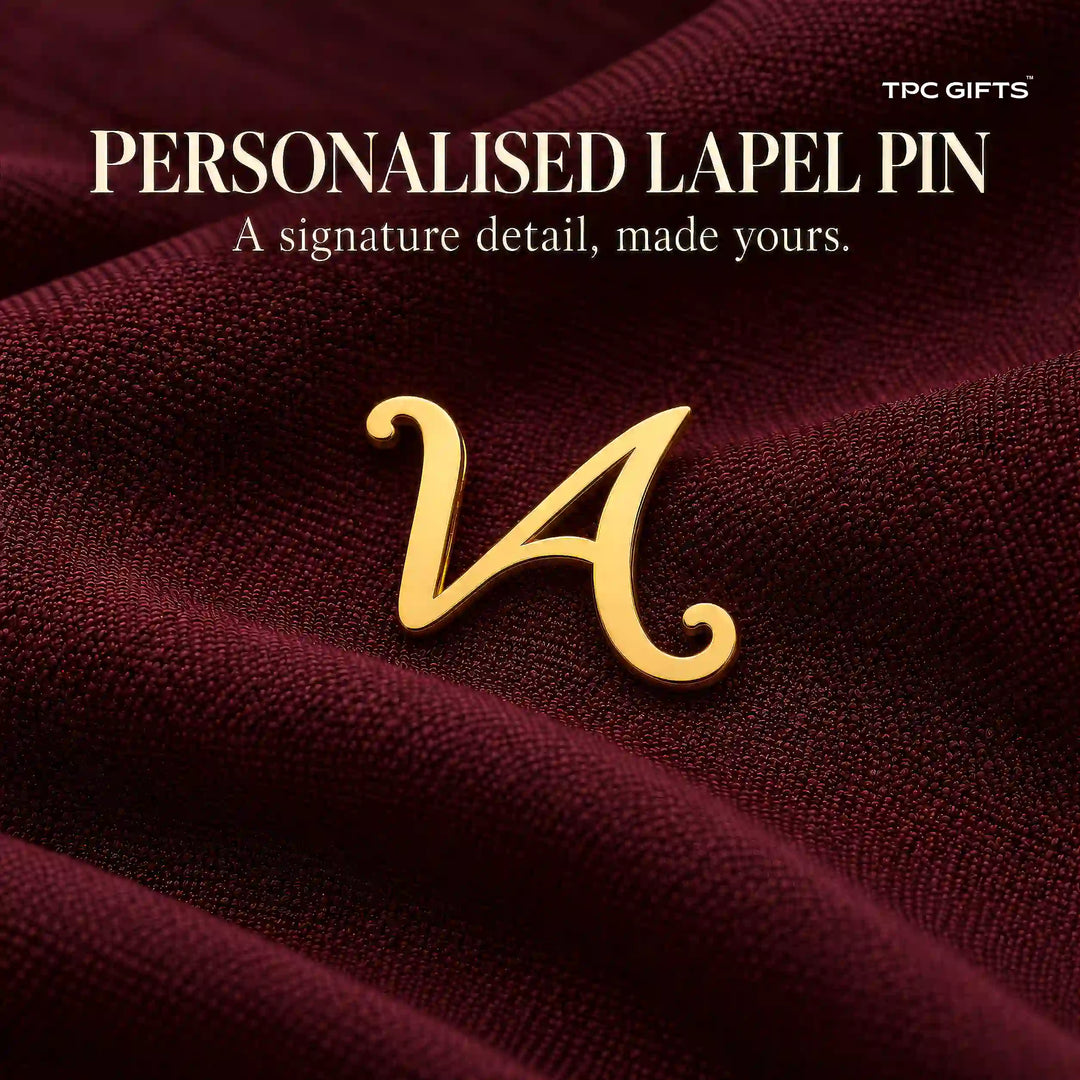 Personalised gold tone script initial lapel pin on burgundy fabric