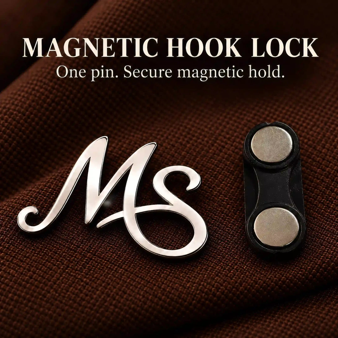 Silver tone initial lapel pin with magnetic hook lock shown beside it