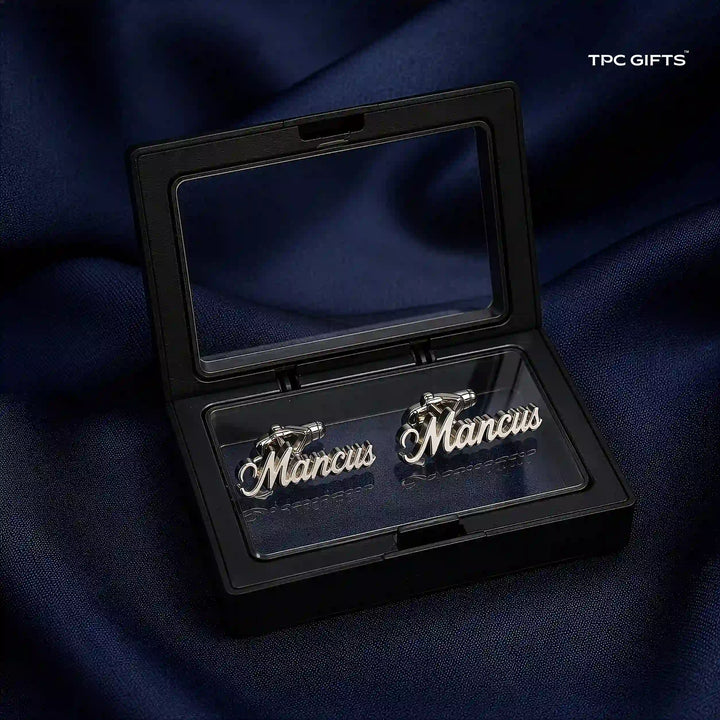 A pair of silver script cufflinks spelling &