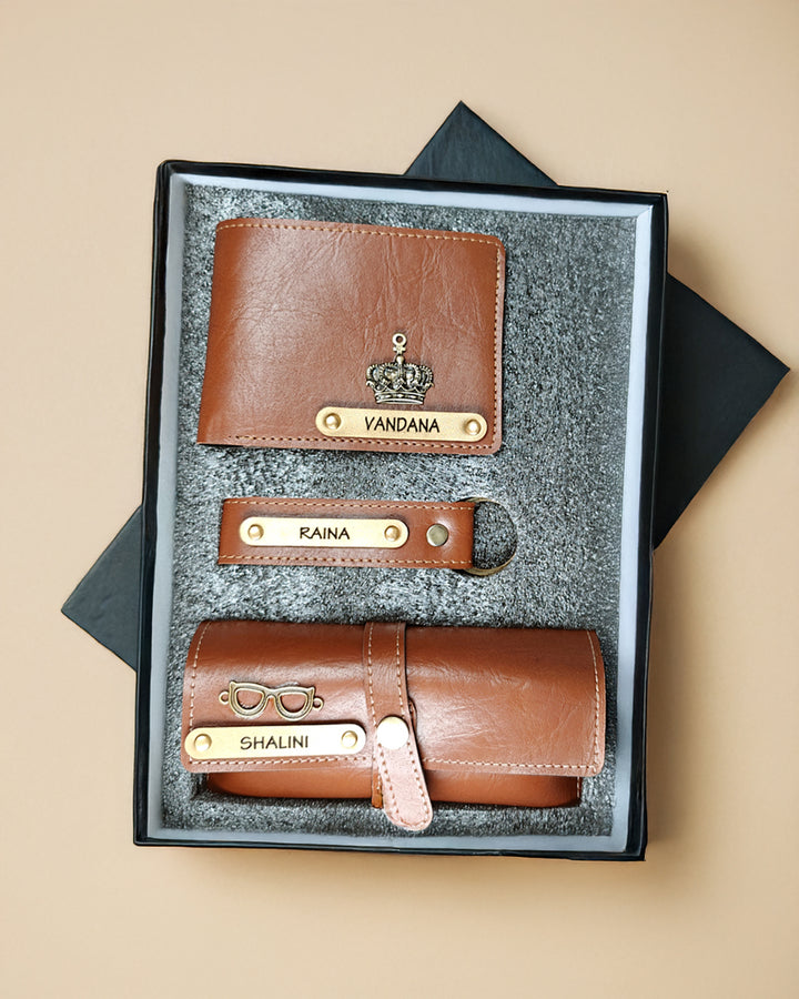 Set of brown leather wallets with nameplates in a black box on a beige background