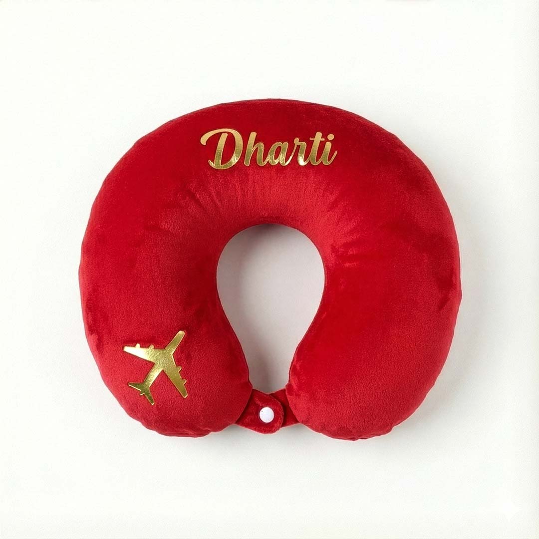 Red travel neck pillow with 'Dharti' and airplane emblem on a white background