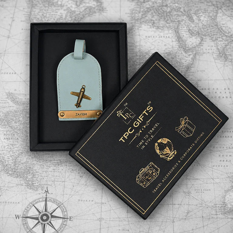 Light blue luggage tag with airplane design in a black box on a world map background