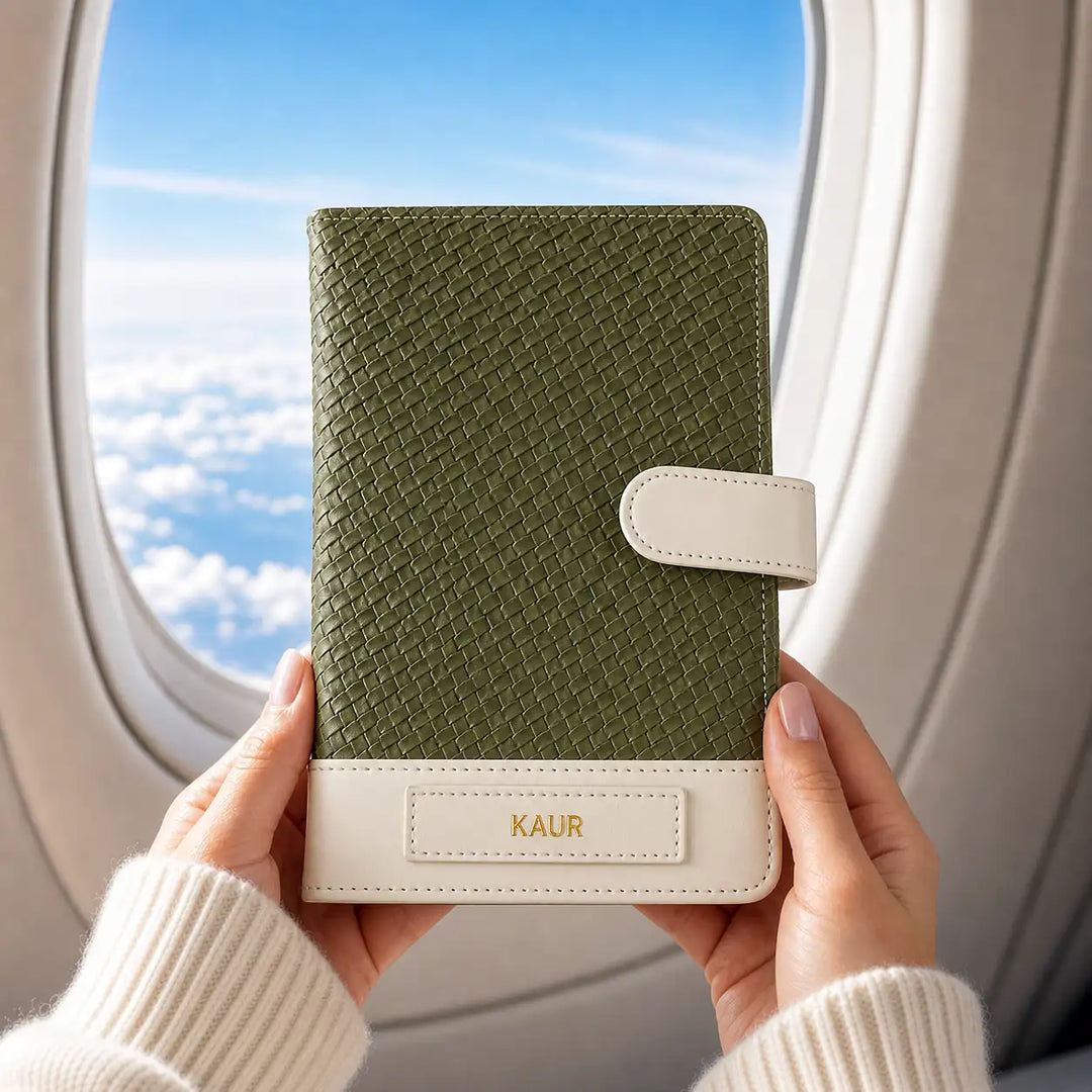 Green weave textured travel organiser wallet  held by hands with a plane window in the background - TPC Gifts