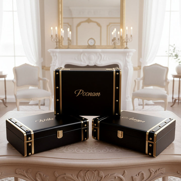Black Trunk boxes with gold accents on a table in a elegant room by TPC Gifts