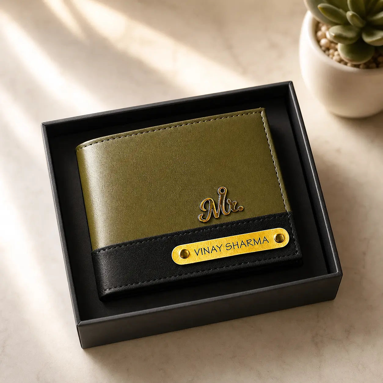 Green and black wallet with personalized nameplate in a box on a light surface by tpc gifts personalized wallet for men