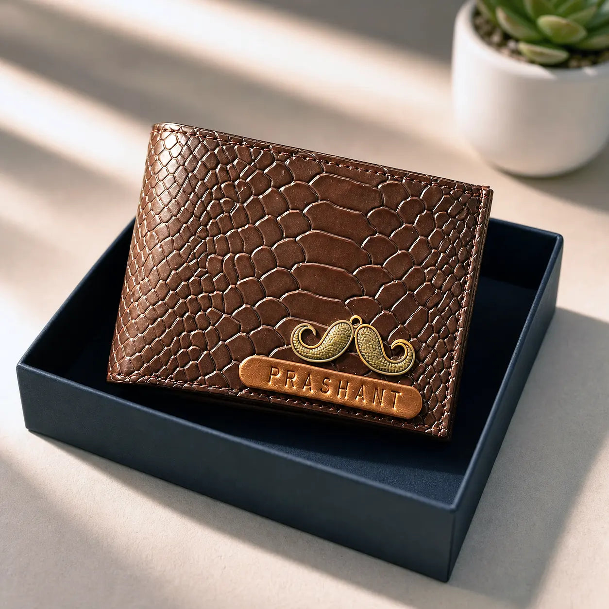 Brown textured wallet with a mustache design and 'Prashant' naming on a black box by tpc gifts personalized wallet for men