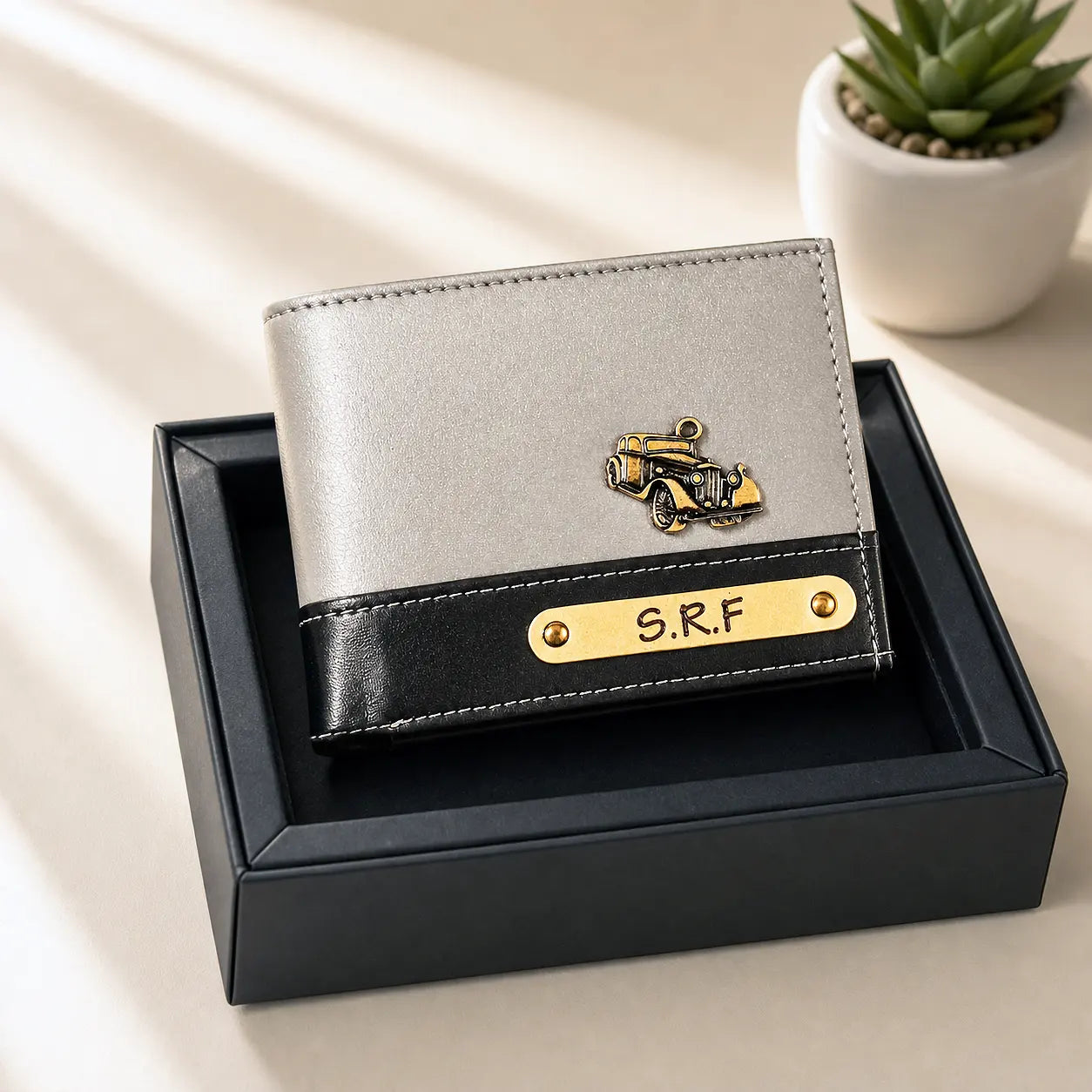 Gray wallet with black accent and gold emblem on a beige surface by tpc gifts personalized wallet for men