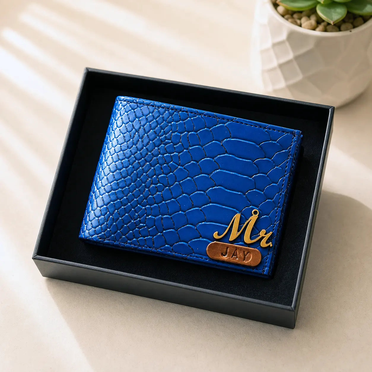Blue textured wallet with 'Mr Jay' naming in a black box on a light surface by tpc gifts personalized wallet for men